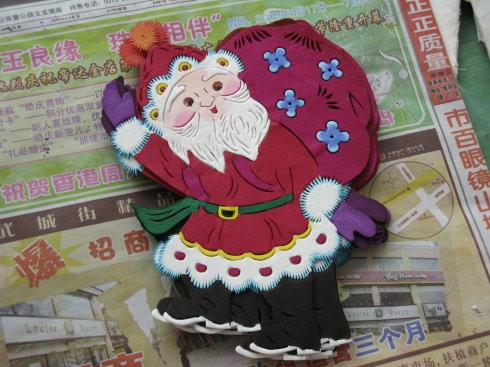 剛剛染好顏色的聖誕老人在紙上晾干，染色也是多層的